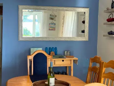 a dining room with a table and a mirror at Dog-Friendly Oceanfront Getaway - Walk to Dining - Private Beach Access in Milford