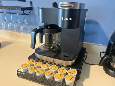 a coffee maker sitting on a table with cupcakes at Dog-Friendly Oceanfront Getaway - Walk to Dining - Private Beach Access in Milford