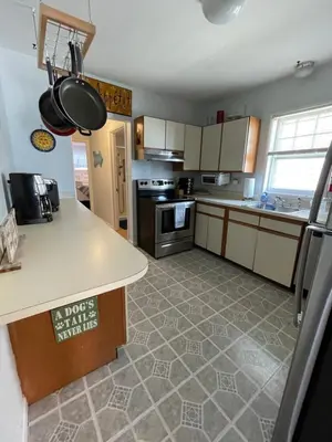 a kitchen with a counter and a stove top oven at Dog-Friendly Oceanfront Getaway - Walk to Dining - Private Beach Access in Milford