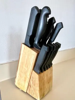 a wooden knife block with black knives in it at Dog-Friendly Oceanfront Getaway - Walk to Dining - Private Beach Access in Milford