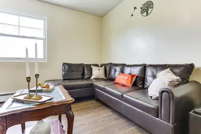 a living room with a leather couch and a table at 2 Mi to The Marketplace Spring Valley Apartment in Spring Valley
