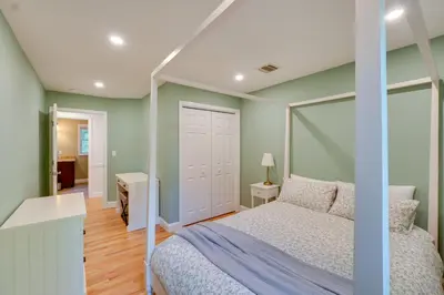 a bedroom with green walls and a bed and a desk at Creek Dips and Smores Catskills Gem