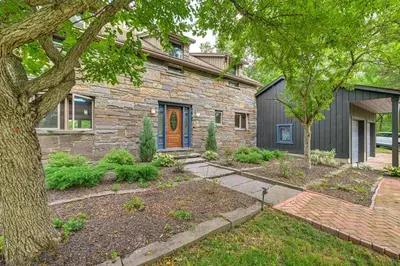 a stone house with a tree in front of it at Riverfront Hudson Valley Gem with Beach Access! in Athens