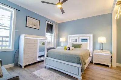 a bedroom with blue walls and a bed with a dresser at New York City Dreams - 10 Mins in Union City