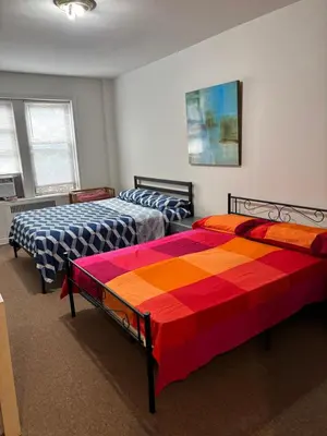 a bedroom with two beds with colorful sheets at Room in New York in Jackson Heights