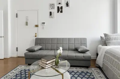 a living room with a couch and a glass table at Heavenly Stays in New York