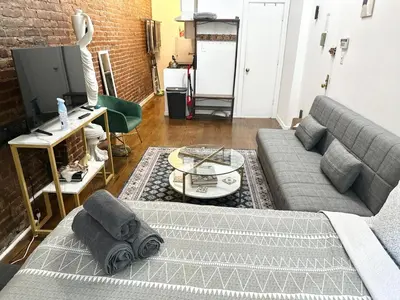 a living room with a couch and a table at Heavenly Stays in New York
