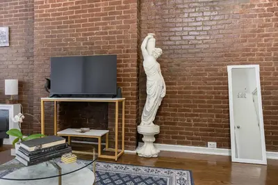 a statue of a woman in a living room at Heavenly Stays in New York