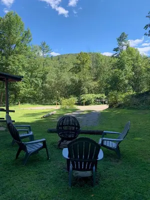 a group of chairs and a table in the grass at Green River Cottage in Guilford