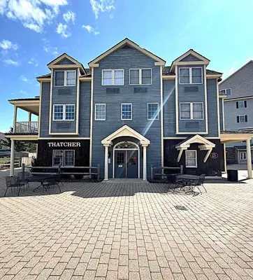 a large house with benches in front of it at Luxury Jiminy Ski On Off Village Ctr Condo Sleeps4 in Hancock