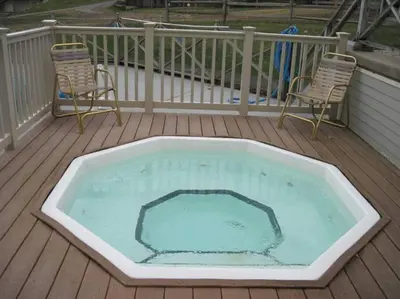 a large swimming pool on a deck with two chairs at Luxury Jiminy Ski On Off Village Ctr Condo Sleeps4 in Hancock