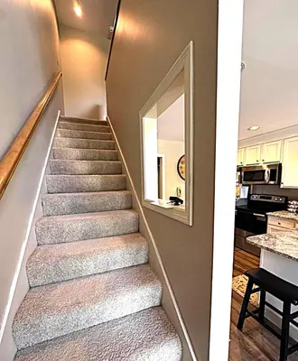 a staircase in a house with a mirror and a kitchen at Luxury Jiminy Ski On Off Village Ctr Condo Sleeps4 in Hancock
