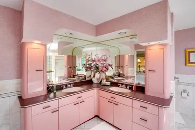 a bathroom with two sinks and a large mirror at Pool Table and Deck Luxury Mansion in Niskayuna! in Niskayuna
