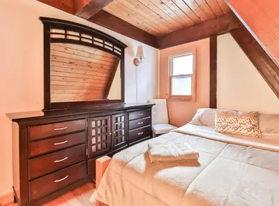 a bedroom with a large bed and a wooden ceiling at Triangle Tranquility Unique A Frame 6 BR Home in Lanesville
