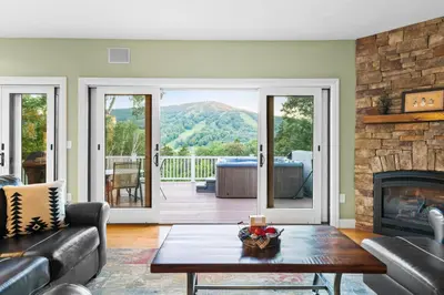a living room with a couch and a fireplace at Escape to Mountainview Haven Spacious Retreat with Hot Tub at Mount Snow in West Dover