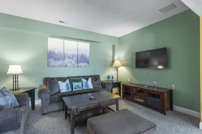 a living room with a couch and a tv at Escape to Mountainview Haven Spacious Retreat with Hot Tub at Mount Snow in West Dover
