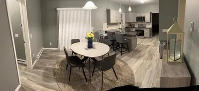 a kitchen and dining room with a table and chairs at Escape to Luxury in the Poconos Your Year-Round Family Retreat in Daleville