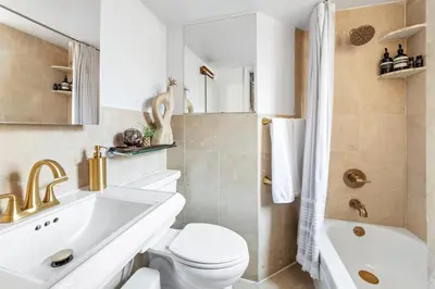 a bathroom with a toilet and a sink and a tub at Studio Nolita in New York