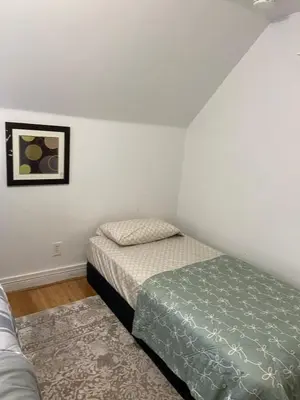 a bedroom with two beds and a picture on the wall at Cjay home 3 in Jersey City