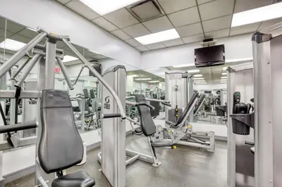 a gym with several treadmills and machines at Blueground Murray Hill fitness center nr MetLife NYC-1929 in New York