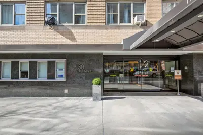 a building with a potted plant in front of it at Blueground Murray Hill fitness center nr MetLife NYC-1929 in New York