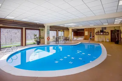 a large swimming pool in a large room with a large ceiling at 5A Mountain Village - Unit A in Dover