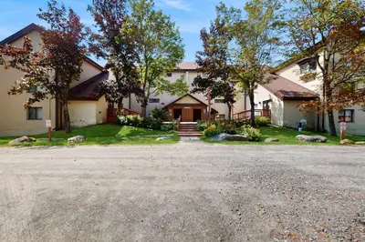a house with a driveway in front of it at 5A Mountain Village - Unit A in Dover