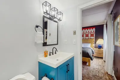 a bathroom with a sink and a toilet and a bedroom at 5B Mountain Village- Unit B in Dover