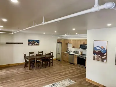 a kitchen and dining room with a table and chairs at Luxury 2 Bedroom Townhome 102 in Wilmington