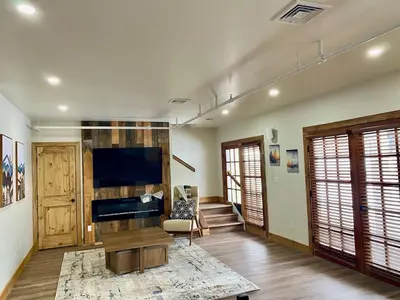 a living room with a flat screen tv and a couch at Luxury 2 Bedroom Townhome 102 in Wilmington