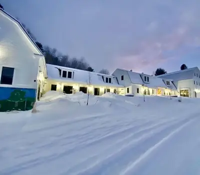 a row of white houses in the snow at Luxury 2 Bedroom Townhome 102 in Wilmington