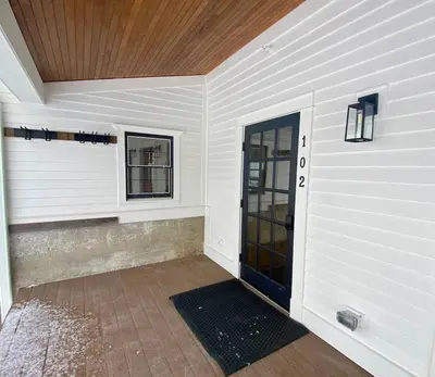 a front door of a house with a wooden ceiling at Luxury 2 Bedroom Townhome 102 in Wilmington