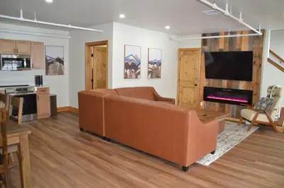 a living room with a couch and a fireplace at Luxury 2 Bedroom Townhome 102 in Wilmington