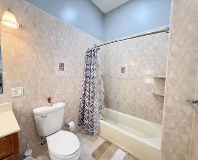 a bathroom with a toilet and a shower and a sink at Huge apartment near NYC, Parking in North Bergen