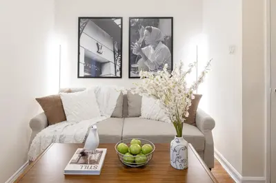 a living room with a couch and a table at Serene 1B Upper East Side Retreat in New York