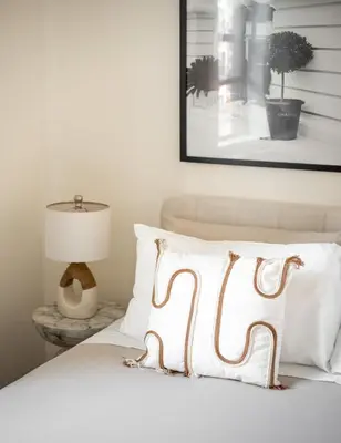 a bed with a white pillow and a picture on the wall at Serene 1B Upper East Side Retreat in New York