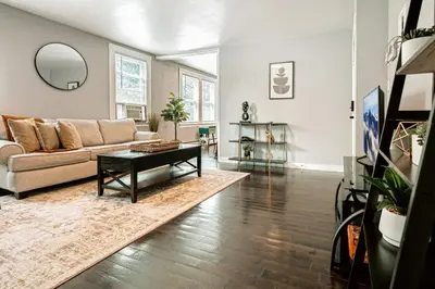 a living room with a couch and a table at A brick's throw away to Sally's! in New Haven