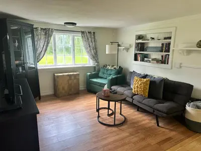 a living room with a couch and a table at Woodford Rest in Woodford