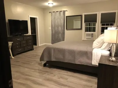 a bedroom with a bed and a flat screen tv at End of the Rainbow in Ballston Lake