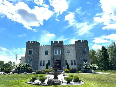 a castle with a fountain in front of it at End of the Rainbow in Ballston Lake