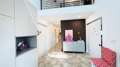 a hallway with a red chair and a desk at Line&Light