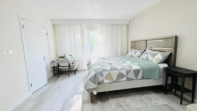 a bedroom with a bed and a table and a window at Line&Light
