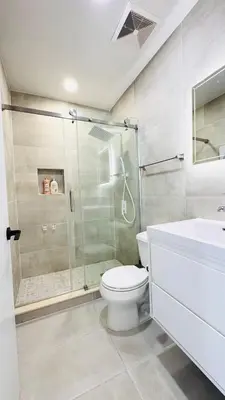 a bathroom with a shower and a toilet and a sink at Line&Light