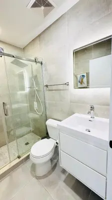 a bathroom with a toilet and a shower and a sink at Line&Light