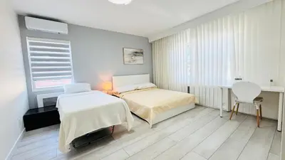 a bedroom with a bed and a desk and a table at Line&Light