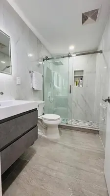 a bathroom with a shower and a toilet and a sink at Line&Light