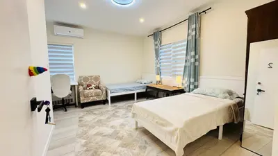 a bedroom with a bed and a couch and a chair at Line&Light