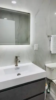a white bathroom with a sink and a mirror at Line&Light