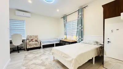 a bedroom with a bed and a couch and a chair at Line&Light