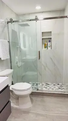 a bathroom with a toilet and a glass shower at Line&Light
